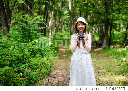 一幅年輕女子在綠樹環繞下的肖像畫。 一幅年輕女子在綠樹環繞下的肖像畫。 141620855