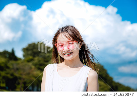 A woman smiling under the summer blue sky. A woman smiling under the summer blue sky. 141620877