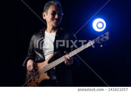 Senior man playing bass Senior man playing bass 141621057