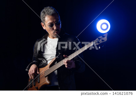 Senior man playing bass Senior man playing bass 141621076