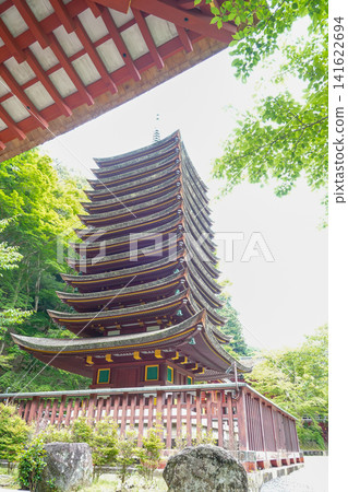 The thirteen-story pagoda of Tanzan Shrine in Sakurai City, Nara Prefecture, amidst the refreshing greenery. The thirteen-story pagoda of Tanzan Shrine in Sakurai City, Nara Prefecture, amidst the refreshing greenery. 141622694