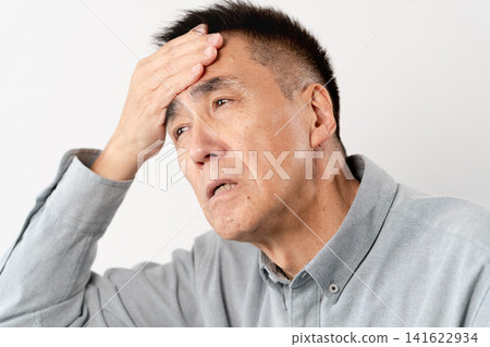 A senior man in casual clothes standing – a lifestyle image. A senior man in casual clothes standing – a lifestyle image. 141622934