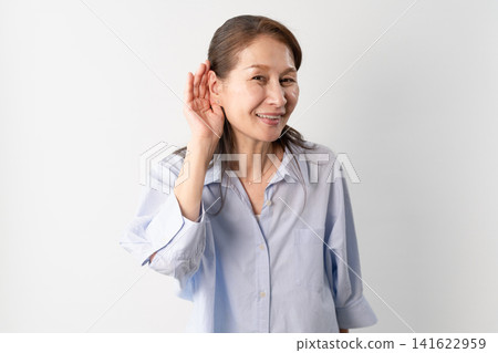 A senior woman in casual clothes standing – a lifestyle image. A senior woman in casual clothes standing – a lifestyle image. 141622959