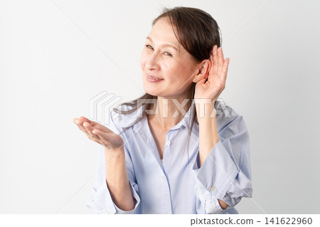 A senior woman in casual clothes standing – a lifestyle image. A senior woman in casual clothes standing – a lifestyle image. 141622960