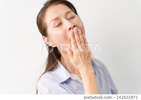 A senior woman in casual clothes standing – a lifestyle image. A senior woman in casual clothes standing – a lifestyle image. 141622971