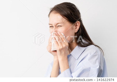 A senior woman in casual clothes standing – a lifestyle image. A senior woman in casual clothes standing – a lifestyle image. 141622974
