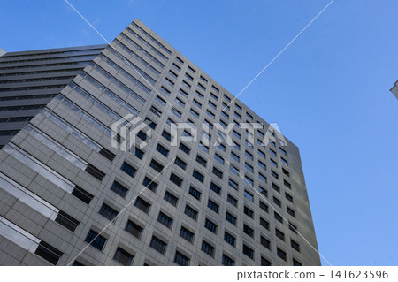 A massive office building with a solid exterior that stands out against the urban sky (Otemachi, Tokyo) A massive office building with a solid exterior that stands out against the urban sky (Otemachi, Tokyo) 141623596
