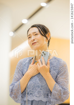 A middle-aged woman who finds happiness through her fan activities. A middle-aged woman who finds happiness through her fan activities. 141623847