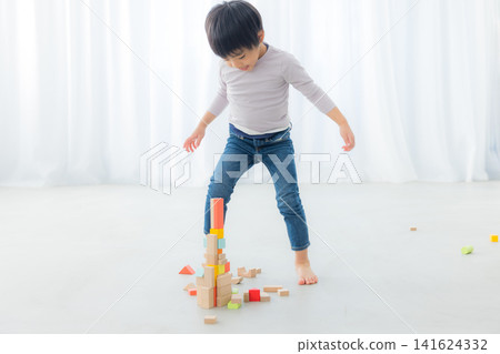 Boy playing with building blocks Boy playing with building blocks 141624332