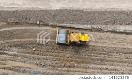 Aerial view motor grader civil at construction site, Motor grader work on construction site, Road grader on road construction site machine work on the construction of new road. Aerial view motor grader civil at construction site, Motor grader work on construction site, Road grader on road construction site machine work on the construction of new road. 141625276