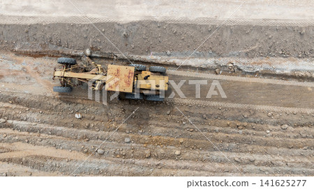 Aerial view motor grader civil at construction site, Motor grader work on construction site, Road grader on road construction site machine work on the construction of new road. Aerial view motor grader civil at construction site, Motor grader work on construction site, Road grader on road construction site machine work on the construction of new road. 141625277