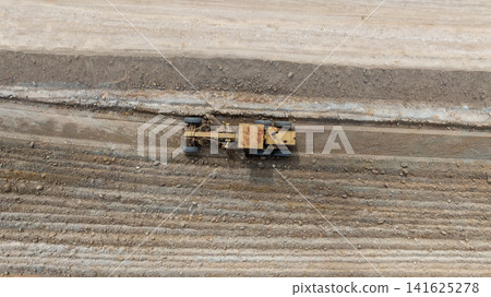 Aerial view motor grader civil at construction site, Motor grader work on construction site, Road grader on road construction site machine work on the construction of new road. Aerial view motor grader civil at construction site, Motor grader work on construction site, Road grader on road construction site machine work on the construction of new road. 141625278