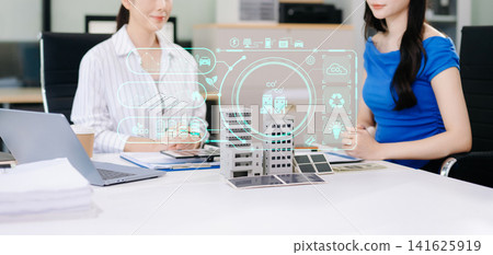 Business professionals discussing smart city investment with ESG, renewable energy, solar technology, and digital building analytics in a modern office. Business professionals discussing smart city investment with ESG, renewable energy, solar technology, and digital building analytics in a modern office. 141625919