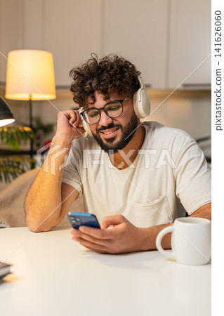 Arabian man in wireless headphones leans back listens chill music eyes closed slow nod enjoys peace Arabian man in wireless headphones leans back listens chill music eyes closed slow nod enjoys peace 141626060