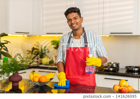 Indian man cleaning kitchen table with spray and cloth for home routine and neat domestic care task Indian man cleaning kitchen table with spray and cloth for home routine and neat domestic care task 141626095