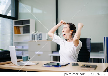 Asian business woman are delighted and happy with the work they do on their tablet, laptop and taking notes at the office. Asian business woman are delighted and happy with the work they do on their tablet, laptop and taking notes at the office. 141626162