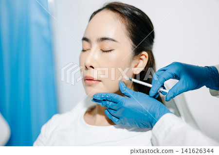 Doctor consulting patient in beauty clinic, skincare analysis, aesthetic treatment planning, professional advice, clean medical setting, modern cosmetic care for healthy skin. 141626344