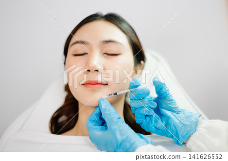 Dermatologist Injecting Botox or Facial Filler Treatment for Young Asian Woman at Aesthetic Clinic Dermatologist Injecting Botox or Facial Filler Treatment for Young Asian Woman at Aesthetic Clinic 141626552