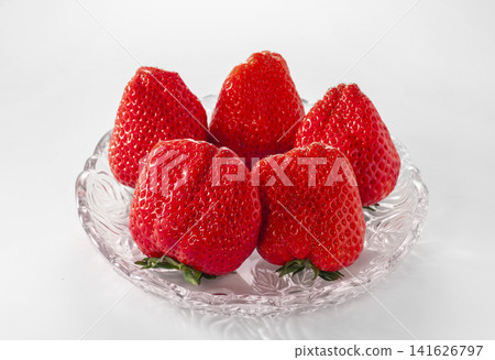 Large, ripe strawberries grown in greenhouses: A scene of harvesting fresh, domestically grown strawberries. Large, ripe strawberries grown in greenhouses: A scene of harvesting fresh, domestically grown strawberries. 141626797