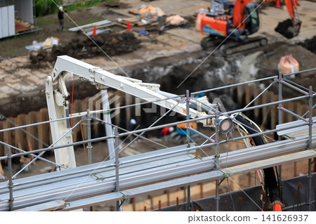 Concrete pouring to upper floors using a pump truck boom Concrete pouring to upper floors using a pump truck boom 141626937