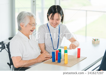 Senior women undergoing rehabilitation at nursing homes and rehabilitation facilities, and female occupational therapists. Senior women undergoing rehabilitation at nursing homes and rehabilitation facilities, and female occupational therapists. 141627287