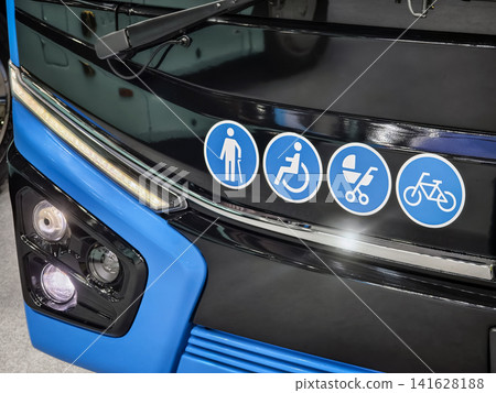 Sign showing accessibility features on a bus in a city transport setting 141628188