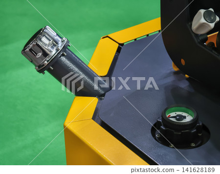 Filling neck of construction machinery in a workshop setting during daytime hours Filling neck of construction machinery in a workshop setting during daytime hours 141628189