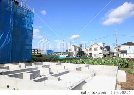 A newly built house that is one step away from completion and a detached house where foundation work has begun. A newly built house that is one step away from completion and a detached house where foundation work has begun. 141628295