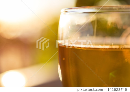 Close Up of Cold Beer in Glass with Bubbles in Sunlight Close Up of Cold Beer in Glass with Bubbles in Sunlight 141628746