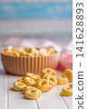 Snack Bowl With Ring-Shaped Savory Crackers On A Light Wooden Table Close-Up Rustic Food Photo 141628893