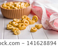 Snack Bowl With Ring-Shaped Savory Crackers On A Light Wooden Table Close-Up Rustic Food Photo 141628894