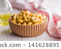 Italian Taralli Snack Rings In Ceramic Bowl With Olive Oil And Pink Checkered Cloth 141628895