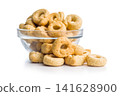 Pile of Golden Italian Taralli Snack Crackers on White Background Close-Up Food Still Life 141628900
