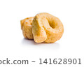 Pile of Golden Italian Taralli Snack Crackers on White Background Close-Up Food Still Life 141628901