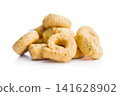 Pile of Golden Italian Taralli Snack Crackers on White Background Close-Up Food Still Life 141628902