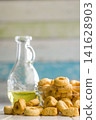 Taralli Italian Crackers With Olive Oil in Bowl On Kitchen Table Rustic Savory Snack 141628903