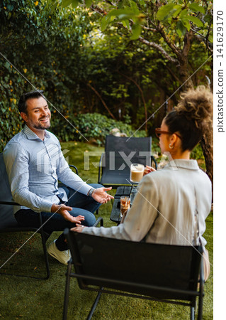 People having friendly conversation at outdoor coffee shop People having friendly conversation at outdoor coffee shop 141629170