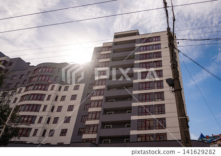 Modern apartment building illuminated by sunlight in an urban neighborhood during a clear day 141629282