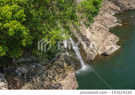 A small waterfall flowing into the Uji River, Uji City, Kyoto Prefecture A small waterfall flowing into the Uji River, Uji City, Kyoto Prefecture 141629286