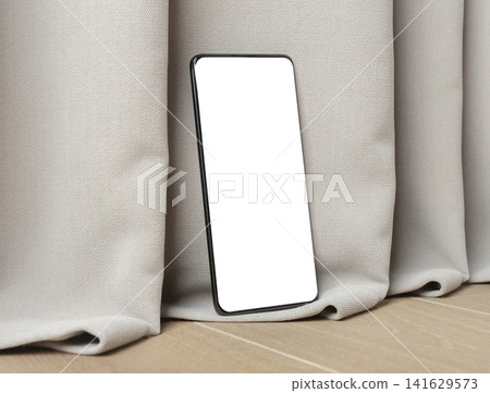 Blank smartphone mockup leaning on curtain fabric. Angled mobile phone with white screen in a minimalist interior. Ideal for app design, advertising, and product presentation.. Blank smartphone mockup leaning on curtain fabric. Angled mobile phone with white screen in a minimalist interior. Ideal for app design, advertising, and product presentation.. 141629573