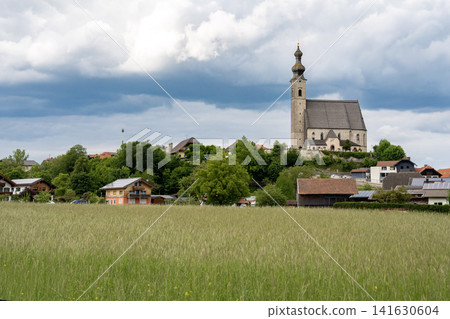 Catholic church of the Assumption of Mary seen from car window while travelling through green fields in rural Bavaria, Germany Catholic church of the Assumption of Mary seen from car window while travelling through green fields in rural Bavaria, Germany 141630604