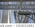 Temporary scaffolding for roof work remains even after the exterior wall renovation is complete. 141631081