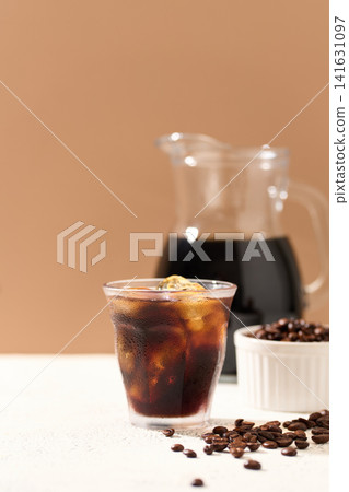 iced coffee poured into a glass iced coffee poured into a glass 141631097