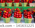 Market in Prague sells fresh fruits in colorful containers during the day 141631225