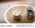 Refreshing homemade iced coffee with frozen cherry juice cubes served beside a cup of black coffee. Cozy home preparation concept with natural light and rustic styling. 141631511