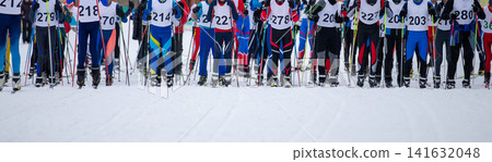 Large group man athletes skiers in starting line Large group man athletes skiers in starting line 141632048