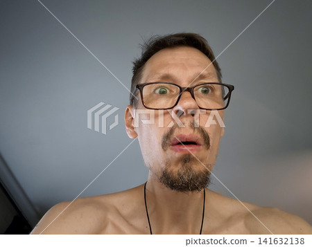 Man showing surprise or shock indoors during daylight hours Man showing surprise or shock indoors during daylight hours 141632138