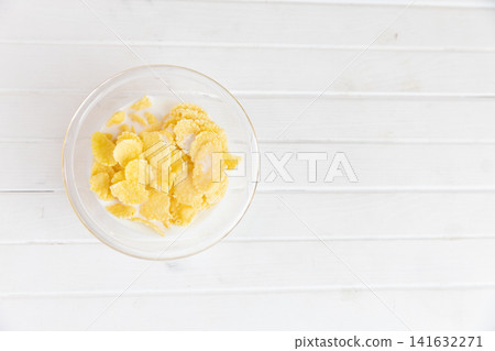 Cornflakes placed on a white table Cornflakes placed on a white table 141632271
