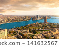 High angle view of Cairo city center and the Nile River under a dramatic orange sunset sky 141632567