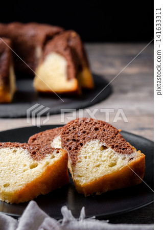 Marble bundt cake sliced on rustic wooden table Marble bundt cake sliced on rustic wooden table 141633311